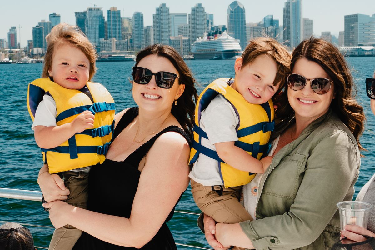 A family on Triton’s deck with the downtown skyline behind
