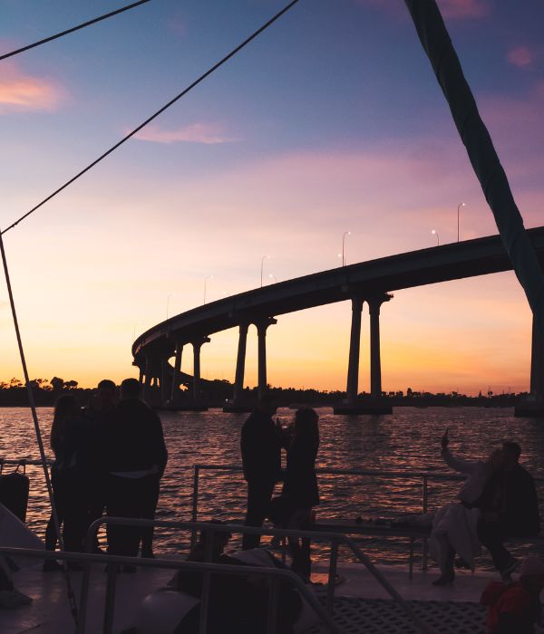 Guests watching the sunset from the deck near the Coronado Bridge