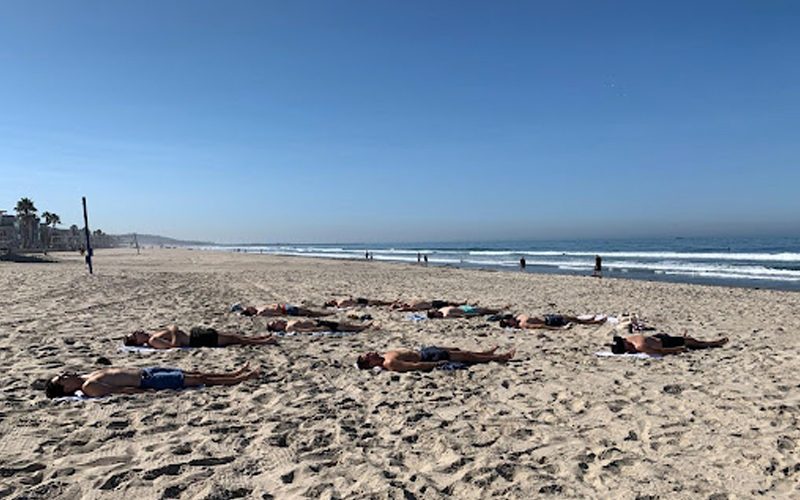 Wide empty stretch of sand and breaking surf at Mission Beach