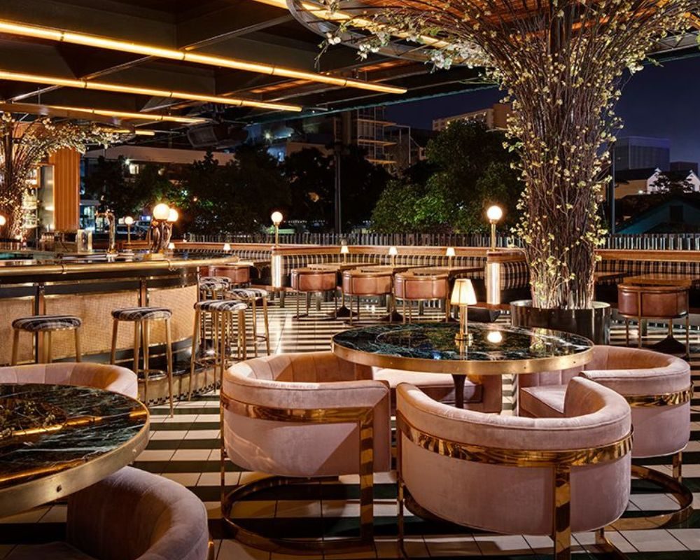 Round leather booths and brass fittings in the dining room at Born & Raised