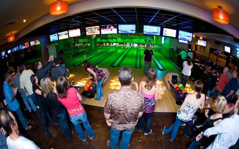 Bowling lanes and a busy bar at East Village Tavern + Bowl
