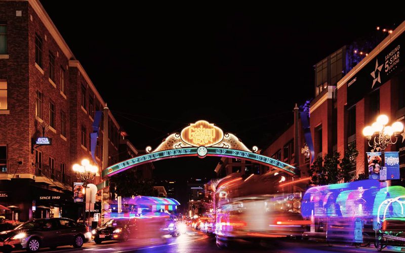 The Gaslamp Quarter sign lit up over Fifth Avenue at night